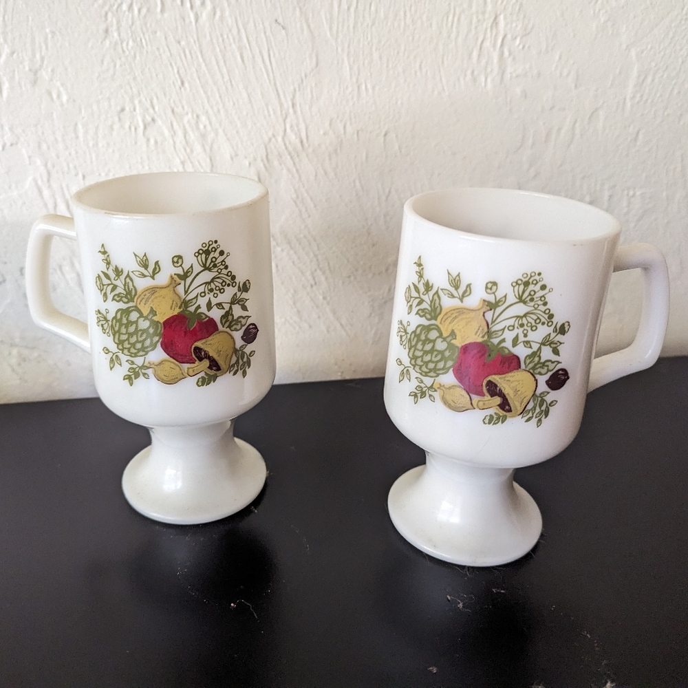 Pair of two footed milk glass mugs